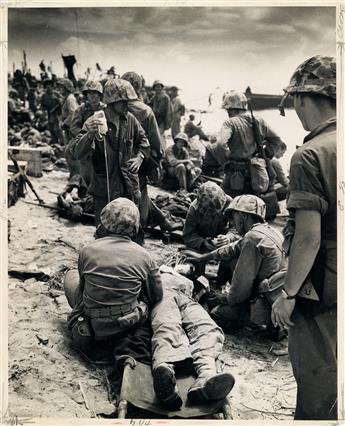 (WORLD WAR II, KOREAN AND VIETNAM WARS) Pair of binders containing a total of 21 press photographs, comprising 9 of the Vietnam War, 10